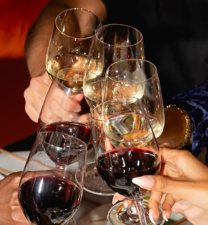Guests toasting over a shared table at Le Souterrain