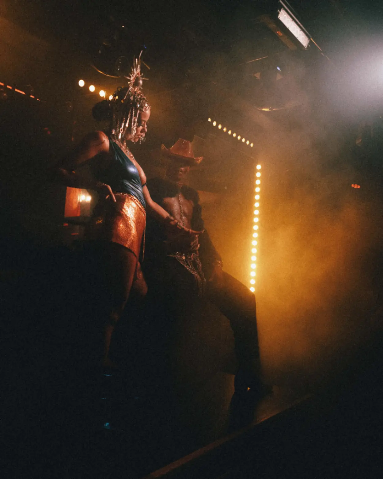 Performer under stage lights during the Dinner Show